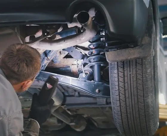 Exhaust and suspension components under a lifted car